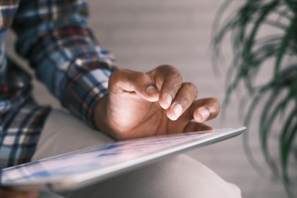 person on tablet looking through information