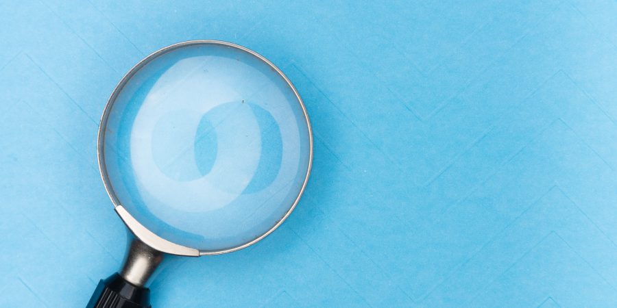 Magnifying glass on a light blue background