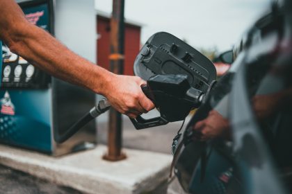 filling up at the station to get more out of a tank of gas