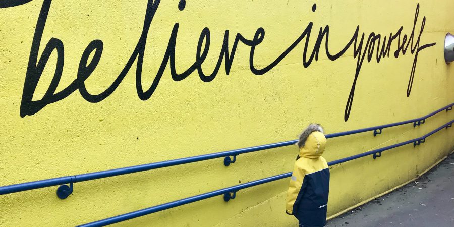 Yellow sign that reads Believe in Yourself