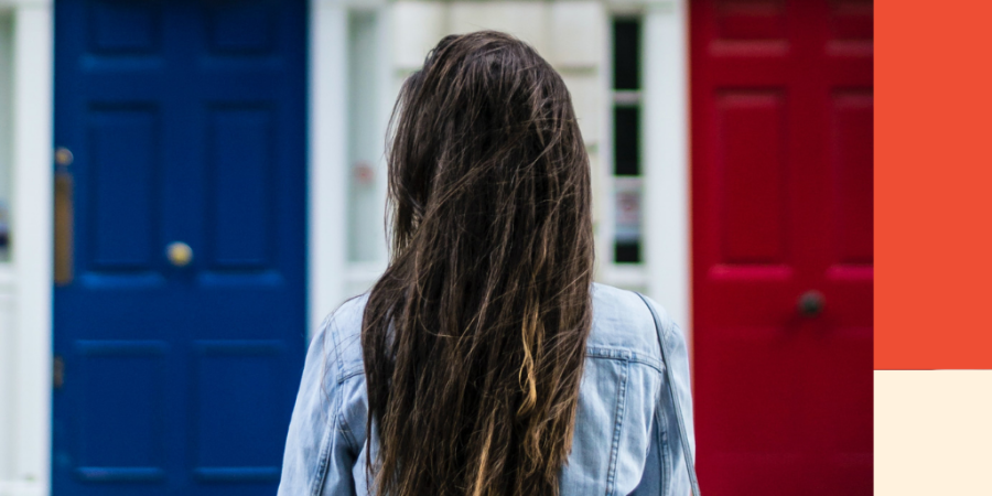 A woman with long brunette hair stands back on in front of a house. Image for a blog post on debt relief: credit counsellors vs debt repayment agents.