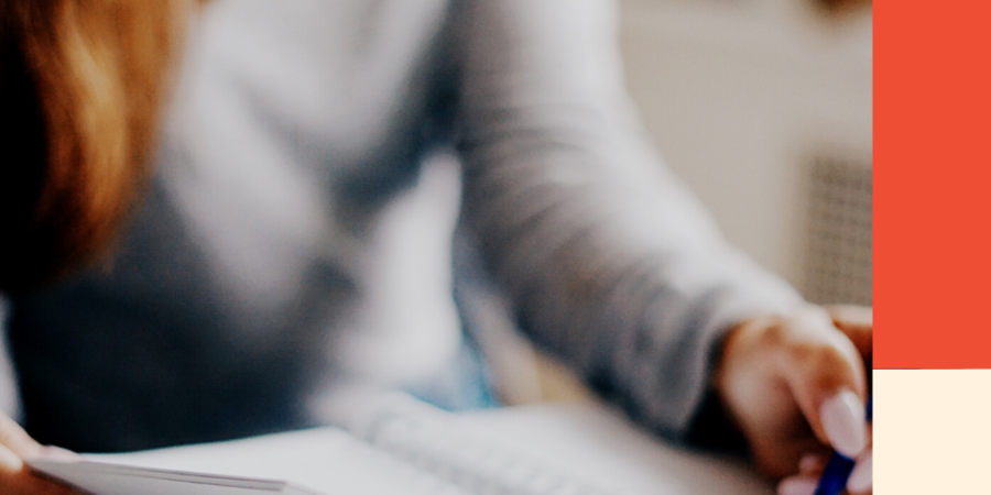 A woman writes in a notebook. Image for a blog post about how debt impacts your credit.