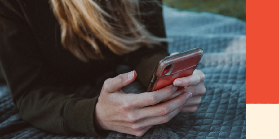 A lady sitting outside looks down at her phone. Image for a blog post on the rules debt collectors must follow in BC.