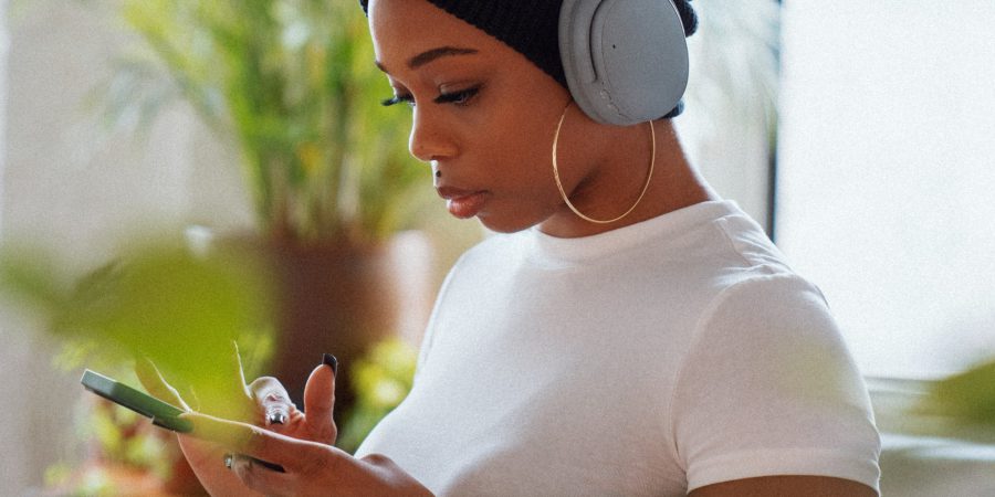woman looking at her phone - BC regulator helps consumer out of unlawful contract